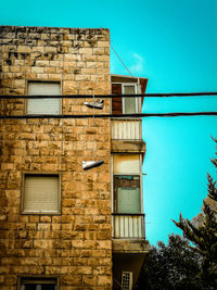 Low angle view of old building against blue sky