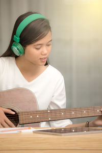 Young woman playing guitar