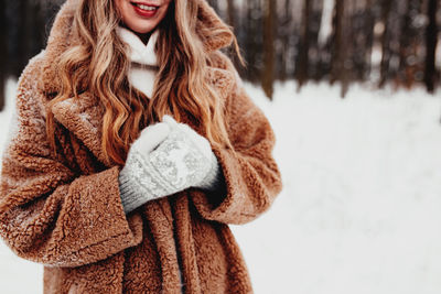 Midsection of woman wearing warm clothing