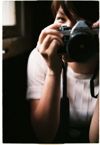 Woman photographing through camera