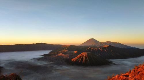 Panoramic view of volcanic landscape against clear sky during sunset