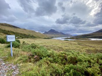 Single-track road in highlands with stac pollaidh mountain in background 