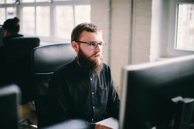 Serious mid adult man working in office