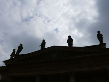 Low angle view of statue against cloudy sky
