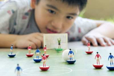 Portrait of boy playing on table