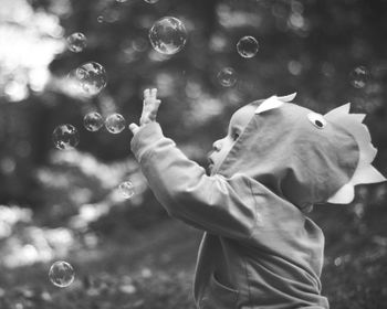 Side view of baby boy with soap bubbles