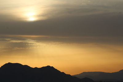 Scenic view of silhouette mountains against sky during sunset