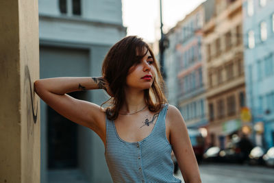 Beautiful young woman standing against built structure