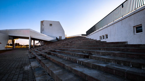 Staircase of building against sky during sunset