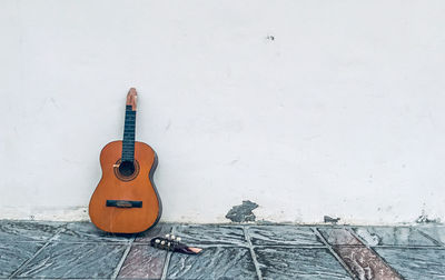 High angle view of guitar against wall