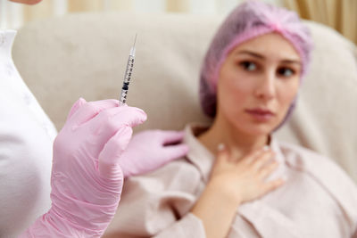 Close-up of doctor holding syringe