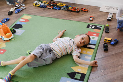 Child with cerebral palsy disability playing on mat, having fun. kid having physical and mental