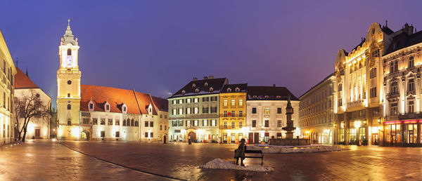 View of illuminated buildings against sky at dusk
