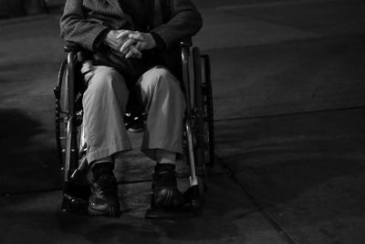 Rear view of two people sitting on road