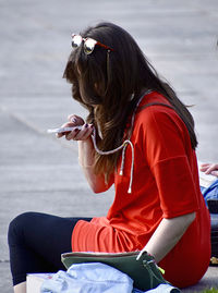 Woman sitting on mobile phone