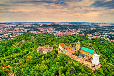 High angle view of houses and trees in town against sky