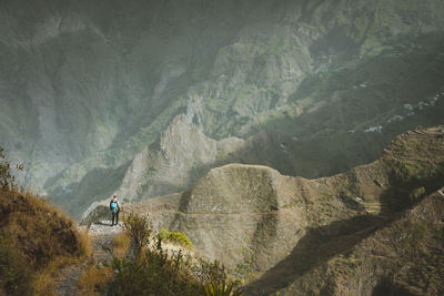 High angle view of woman standing on mountain