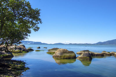 Scenic view of rocks against blue sky