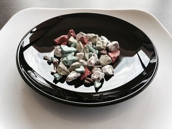 High angle view of stones in plate on table