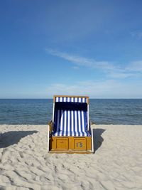 Lifeguard hut on beach against sky