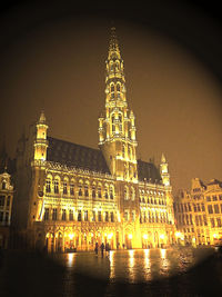 Illuminated clock tower at night