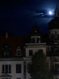 Illuminated buildings against sky at night