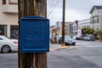 Close-up of information sign on road in city