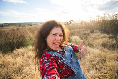 Portrait of smiling young woman on field