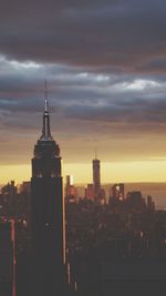 Cityscape against cloudy sky