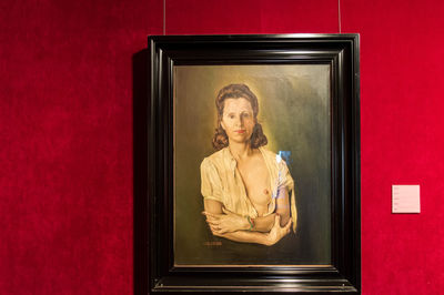 Portrait of young man standing against wall