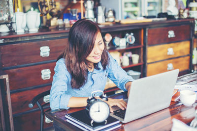 Woman sitting on table in restaurant