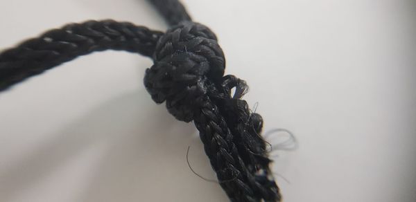 Close-up of rope tied up on table