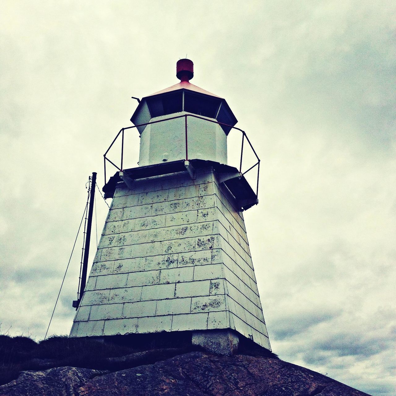 lighthouse, architecture, built structure, building exterior, low angle view, sky, guidance, tower, protection, safety, cloud - sky, security, direction, day, cloud, cloudy, tall - high, outdoors, no people, tall