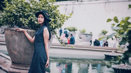 Portrait of young woman standing outdoors