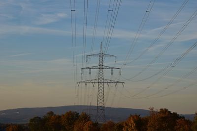 Low angle view of electricity pylon against sky