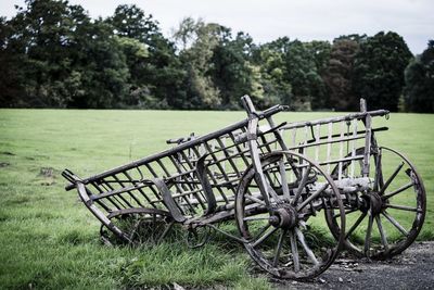 Bicycle on field against trees