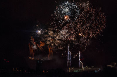 Low angle view of firework display at night