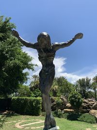 Low angle view of statue against trees in park