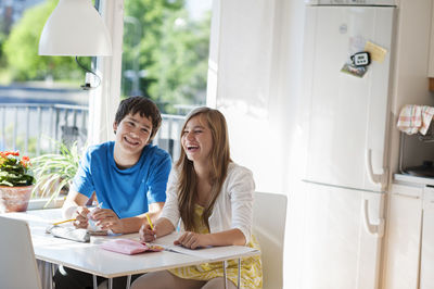 Young couple sitting on table at home