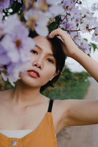 Portrait of woman by flowering plants