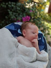 Cute baby boy sleeping on sofa outdoors