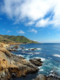 Scenic view of sea against cloudy sky