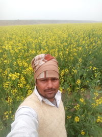 Portrait of man standing in field