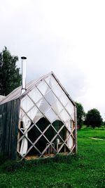 Barn on field against sky