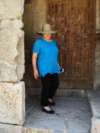 Full length of woman walking on sidewalk