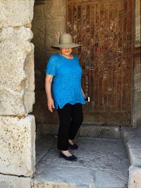 Full length of woman in front of a door