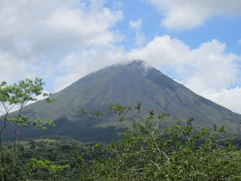 Scenic view of mountains against cloudy sky