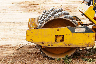 Close-up of yellow abandoned truck on field