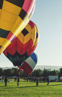 View of hot air balloons on field