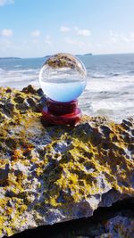 Scenic view of rocks on beach against sky